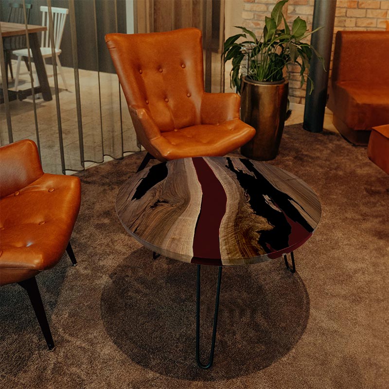 Couchtisch Nussbaum rund mit Epoxidharz weinrot. Modell Gletschersee