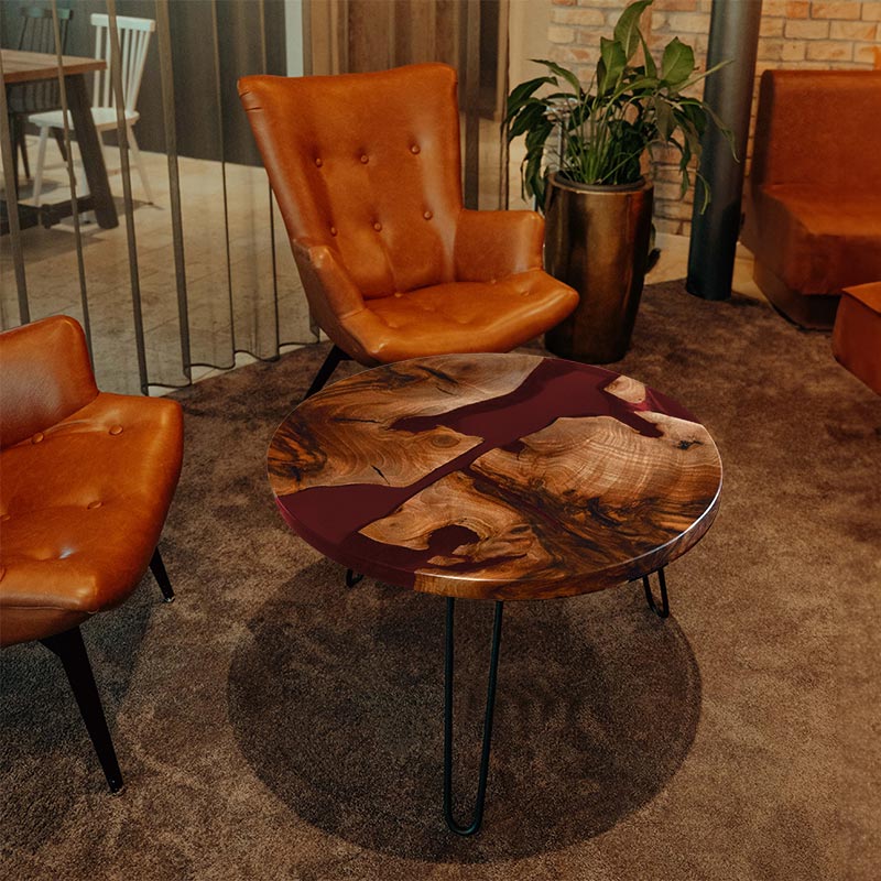 Couchtisch rund aus Nussbaum. Epoxidharz rot. Modell Schluchsee