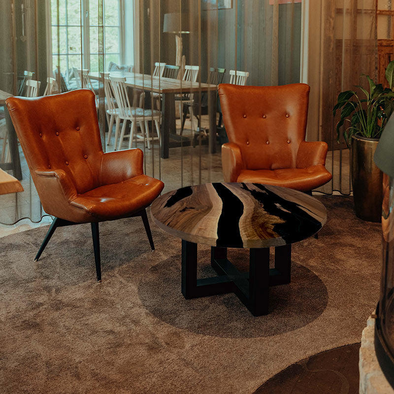 Couchtisch Nussbaum rund mit Epoxidharz schwarz. Modell Gletschersee