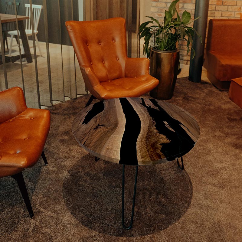 Couchtisch Nussbaum rund mit Epoxidharz schwarz. Modell Gletschersee